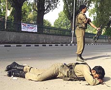 One of the six injured jawans of the Border Security Force lying on the ground after a grenade explosion at the busy Residency Road in Srinagar on Saturday. 