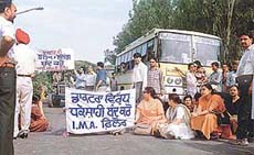 Doctors block traffic on the GT Road in Phillaur on Saturday in protest against the registration of a case against a doctor.