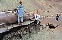 Afghan children play on a burnt-out Soviet army tank, in the village of Malaspa, Panjshir Valley on Saturday.