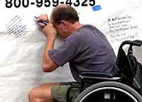 Ed Nichols fights back tears before signing a banner 