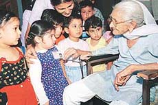 Tiny tots of Evergreen Academy interact with 97-year-old Bira Bai at the Oldage Home.