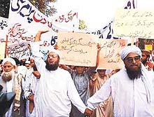 Activists of Pakistan's militant religious parties raise anti-US slogans during a rally.