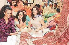 Noyonika Chatterjee admires a saree at the inauguration of a showroom 
