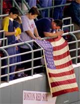 Fans bow their heads for a moment of silence at Fenway Park 