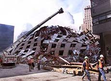 Firefighters hose down the smoldering remains of the World Trade Center as search and rescue operations continued at the site of last week's attack on Tuesday.