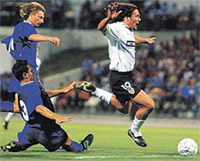 Sergei Begenar (L) and Alexander Svistunov (2nd L) of Chernomorets try to catch Nufete (R) of Valencia