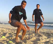 Brazilian and Spanish club Barcelona soccer star Rivaldo Ferreira (L) is observed by his trainer