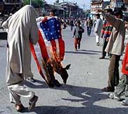 Supporters of the militant-sponsored strike burning USA flag during a protest demonstration at Nowhatta in downtown Srinagar on Friday. 