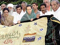 Congress president Sonia Gandhi (centre) at her residence with other congress activists in New Delhi on Saturday with a chaddar which will be placed on her behalf at dargah Sharief Ajmer. 