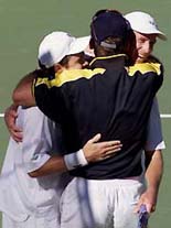 Australian pair Todd Woodbridge (L) and Wayne Arthurs (R) are embraced by team captain John Fitzgerald (C) after they defeated Swdens Magnus Larsson and Jonas Bjorkman in their Davis Cup semifinal doubles match in Sydney on Saturday. 
