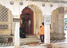 Women wait outside the Durgah, since they are not allowed inside