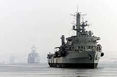 Three British warships cross the Suez Canal through the morning mist on Saturday. 