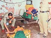A police official examines the body of 35-year-old Mira
