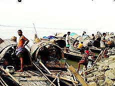 After days hard work in the river Brahmaputra fishermen come to the banks at Guwahati at the Sunday evening market to market the fish they catch during the day.