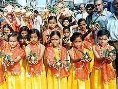 Children and women carrying holy Ganga water praying  for world peace  in Patna on Sunday. 