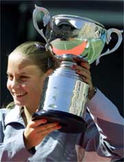 Jelena Dokic of Yugoslavia shows off the trophy after winning the final against Arantxa Sanchez-Vicario