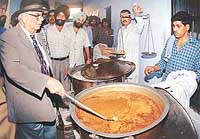 The UT Administrator, Lieut-Gen J.F.R. Jacob (retd), checks the quality of food