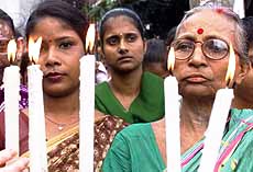 Indian Christians holding candles take part in a peace rally organised by the United Forum of Christians in Calcutta on Monday. 