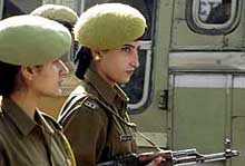 Indian policewomen patrol a street outside the Jammu and Kashmir Legislative Assembly complex in Srinagar on Tuesday. 