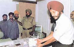 SSP Paramjit Singh Grewal shows the fake currency and printing equipment seized by the police in raids