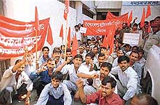 Workers protest against the black marketing of kerosene and rations in Ludhiana on Thursday.