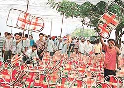 Chairs go over the dais as booths for motor mechanics go under the hammer outside the DCs office in Sector 17, Chandigarh, on Friday.