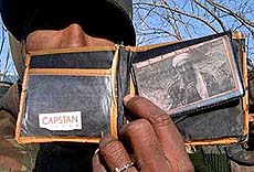 An Army official shows a wallet of one of the eight killed Jaish-e-Mohammad militants