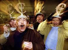 Revellers wear headgear bearing the euro logo 