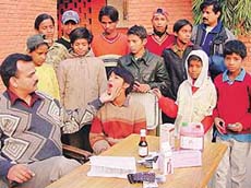 Dr J.S. Thakur, Assistant Professor, Department of Community Medicine, PGI, examines students of Ashiana School in Sector 24, Chandigarh, on Tuesday.