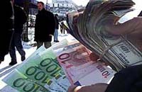 A money-changer in the Kosovo capital Pristina adapts quickly to Europe's new currency