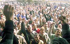 Employees from various banks raise their arms in protest
