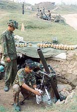 An Indian soldier cleans a mortar launcher in the Akhnoor Sector at the India-Pakistan border on Saturday.