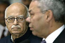 Home Minister L. K. Advani watches as US Secretary of State Colin Powell speaks