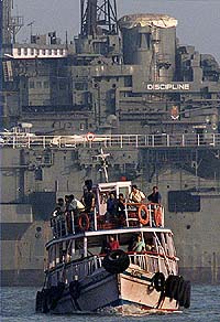 A passenger ferry goes past "Indian Museum ShipVikrant"