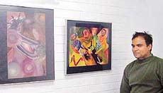 Vijay K. Giri with his painting at the Kalagram art gallery in Chandigarh.