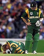Jacques Kallis lies on the ground after twisting his ankle as team-mate Herschelle Gibbs stands by during their one-day match against Australia in Melbourne on Sunday.