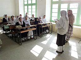 A student reads to her class at a school in Afghanistan