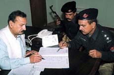 Officials check the recently seized accounts of banned Islamic militant groups in the Punjab provincial city of Multan 