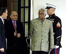 Defence Minister George Fernandes walks past a Marine guard