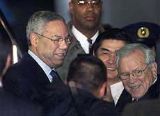 US Secretary of State Colin Powell is welcomed by US Ambassador to Japan Howard Baker