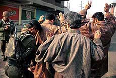 A BSF jawan frisking the residents