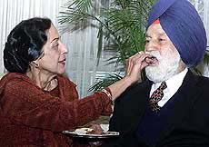 India's first Marshal of the Air Force Arjan Singh being offered a sweet