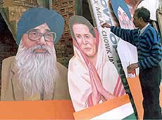 A painter giving final touches to cutouts of Congress President Sonia Gandhi and Punjab Chief Minister Parkash Singh Badal