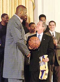 U.S. President George W. Bush receives a basketball