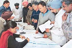 Motor mechanics file income tax returns at a special camp held in the Sector 28 motor market, Chandigarh, on Wednesday.