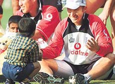 Englands captain Nasser Hussain plays with children suffering from cancer 