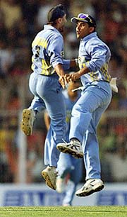 India's Harbhajan Singh (L) and team captain Saurav Ganguly celebrate after Harbhajan dismissed England's Ashley Giles