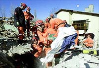 Turkish rescue workers dig into rubble of a three-storey house after a devastating earthquake hit Sultandagi