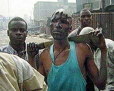 A youth carrying a machete patrols the streets of the volatile Mushin suburb on Sunday