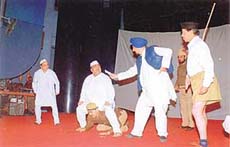 A PNB team participates in a cultural programme showing a politician sitting on a policemans neck.